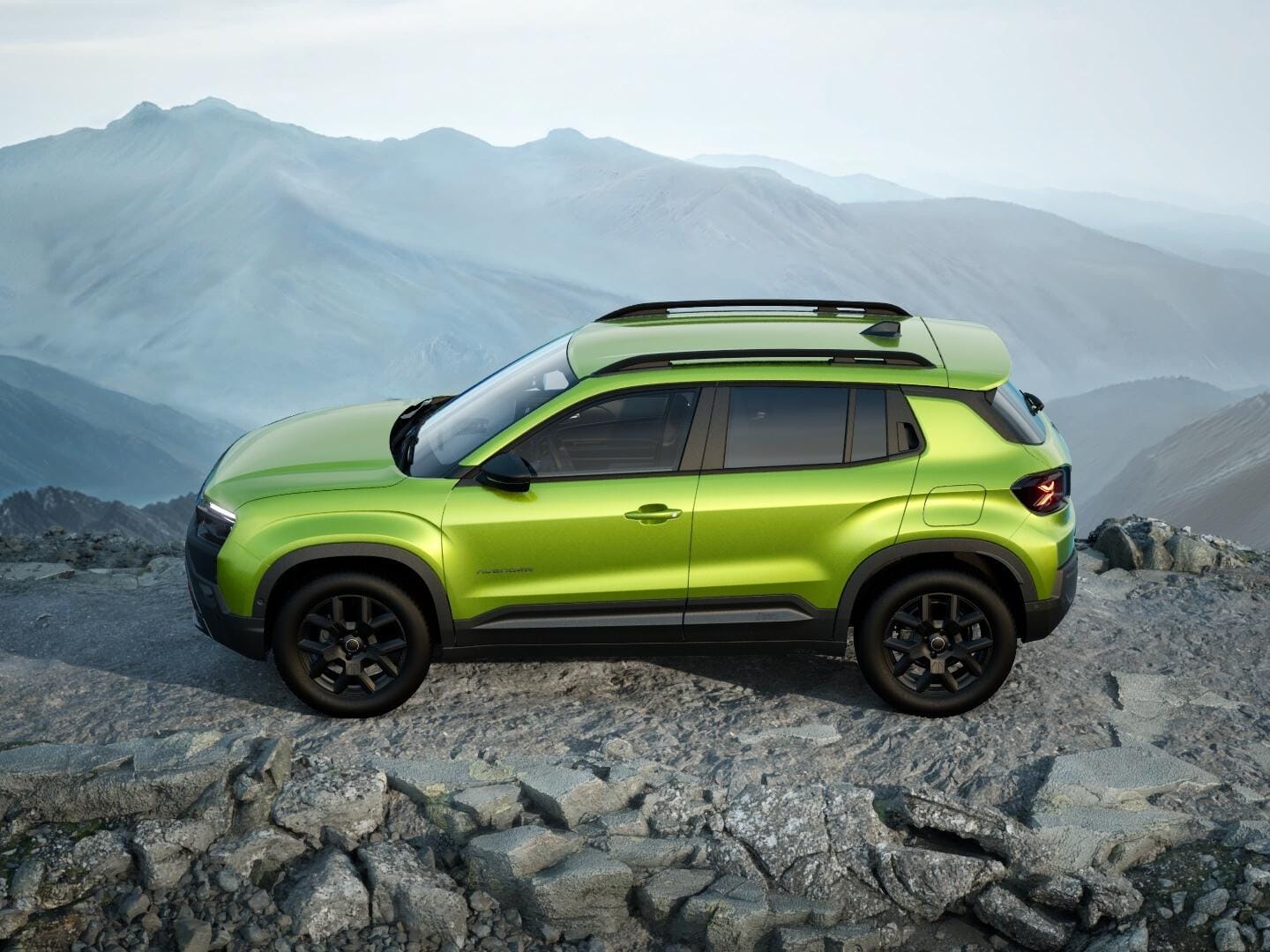 Grüner Jeep Avenger 4xe Upland in Seitenansicht auf felsigem Gelände in den Bergen.