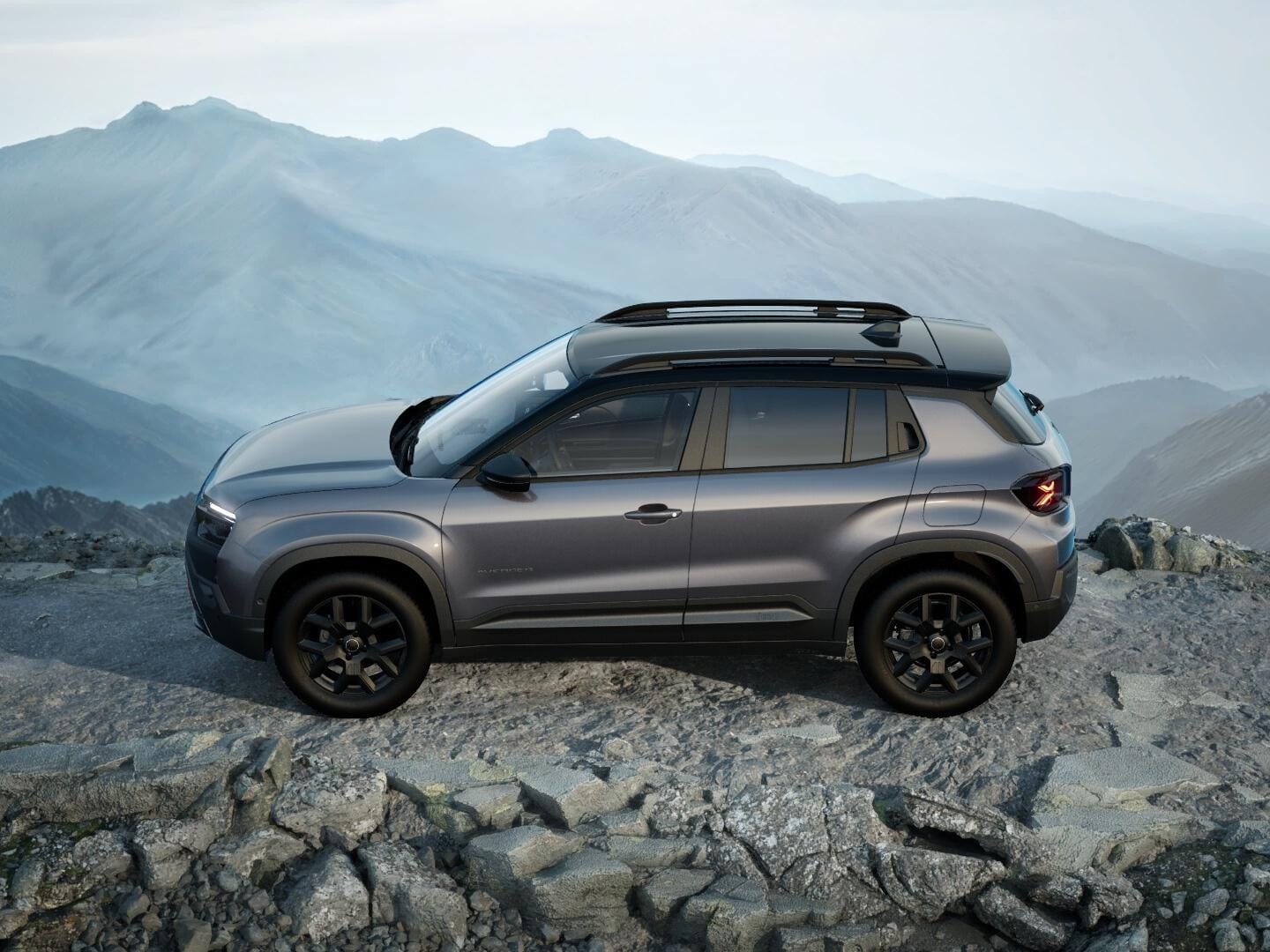Grauer Jeep Avenger 4xe Upland mit schwarzem Dach in Seitenansicht auf felsigem Gelände.