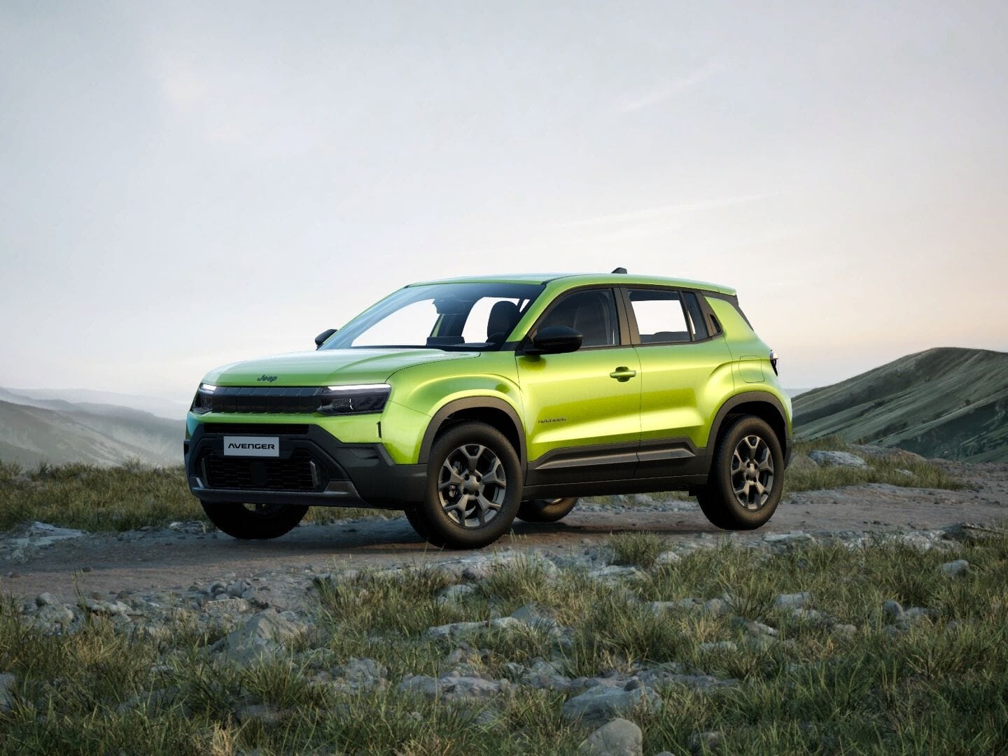 Grüner Jeep Avenger Longitude in Frontansicht vor einer weitläufigen Berglandschaft.
