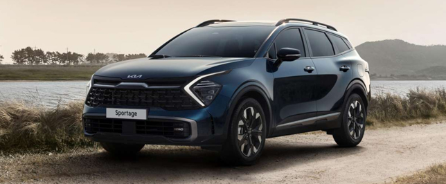 Dunkelblauer Kia Sportage an einem Fluß.
